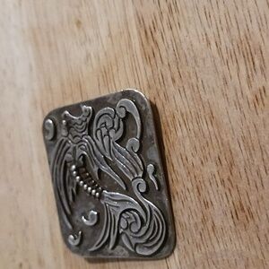 Sterling silver brooch with skeleton drawings on, front